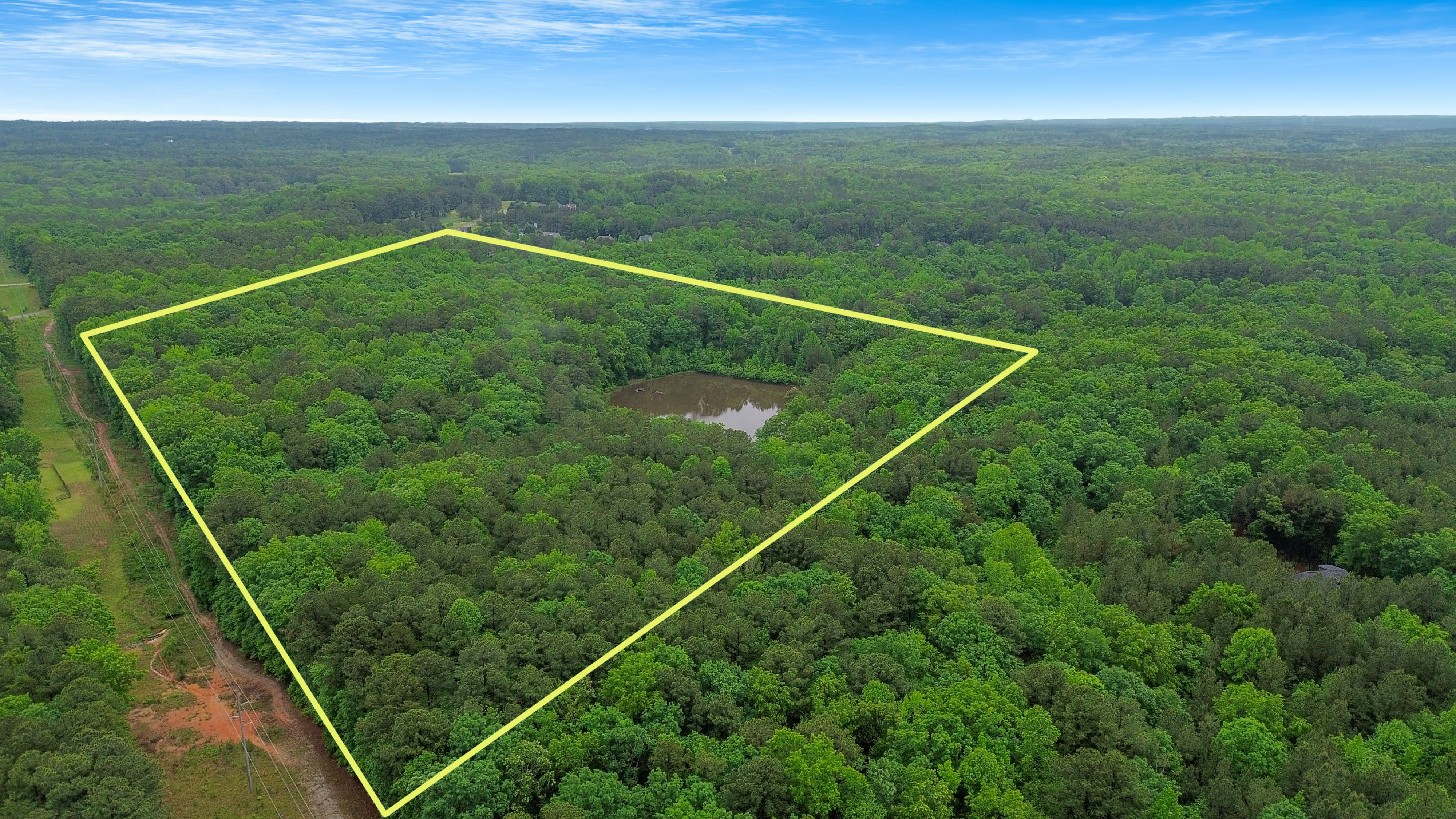 Aerial view of the 40-acre Wake Forest tract with its private 4-acre pond, property boundary outlined