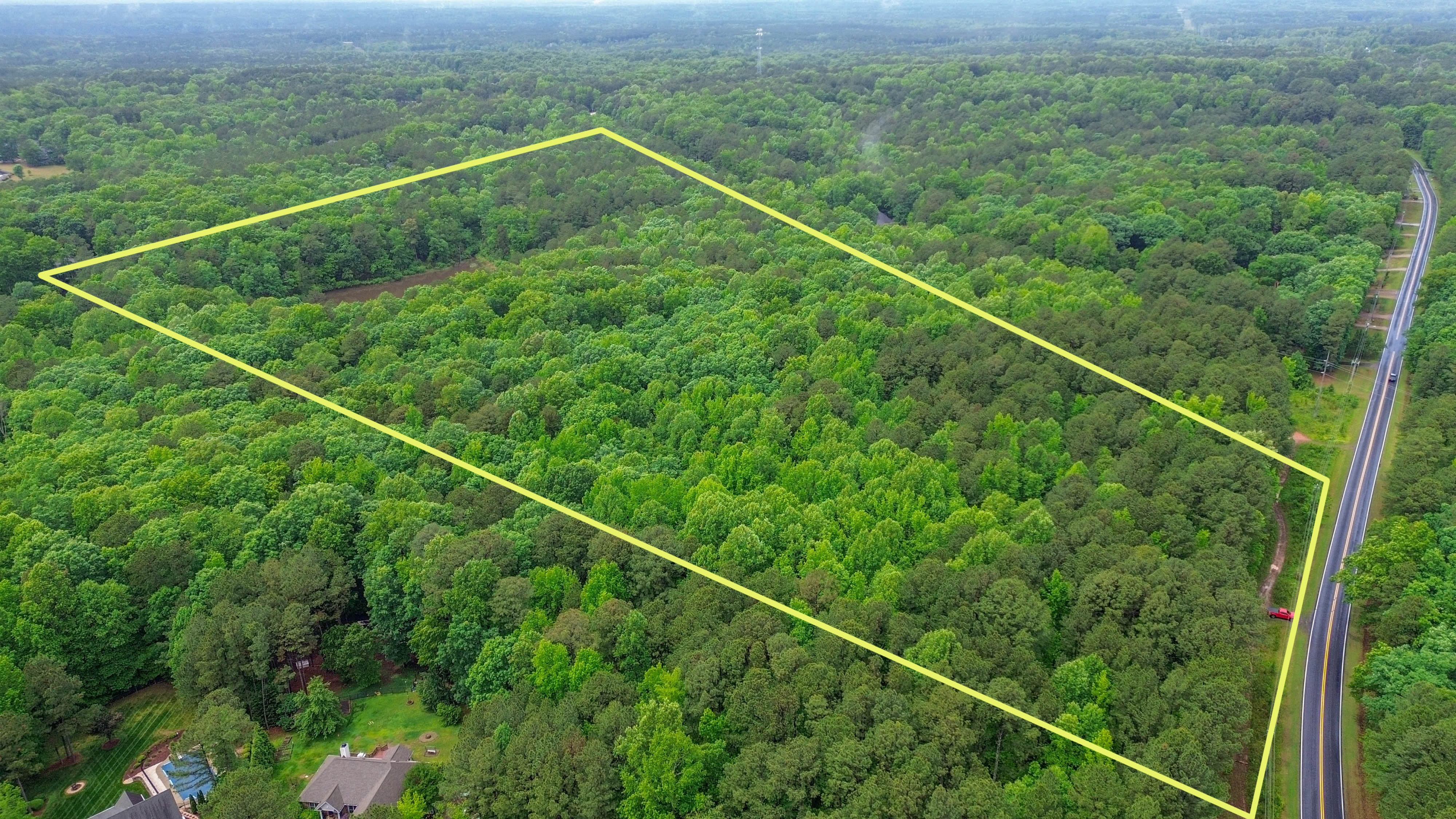 Aerial view of the 40-acre Wake Forest tract along its road frontage, boundary outlined